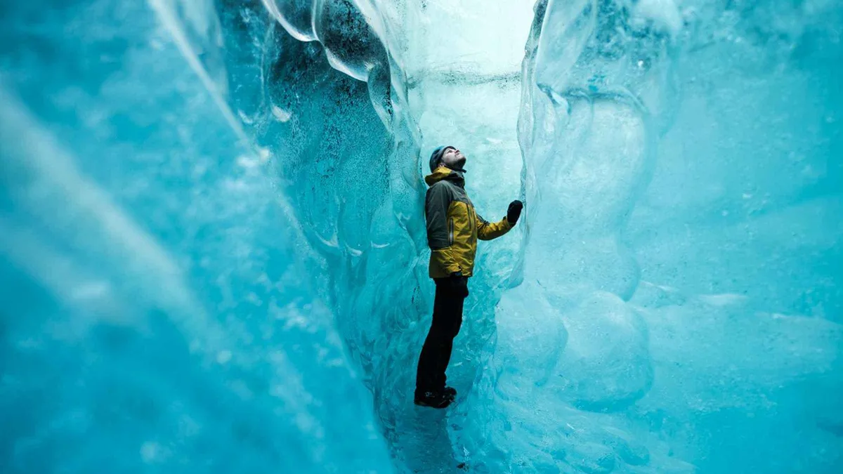 Guide and small group inside a blue ice cave in Breiðamerkurjökull on an Iceland ice cave day tour from Jökulsárlón